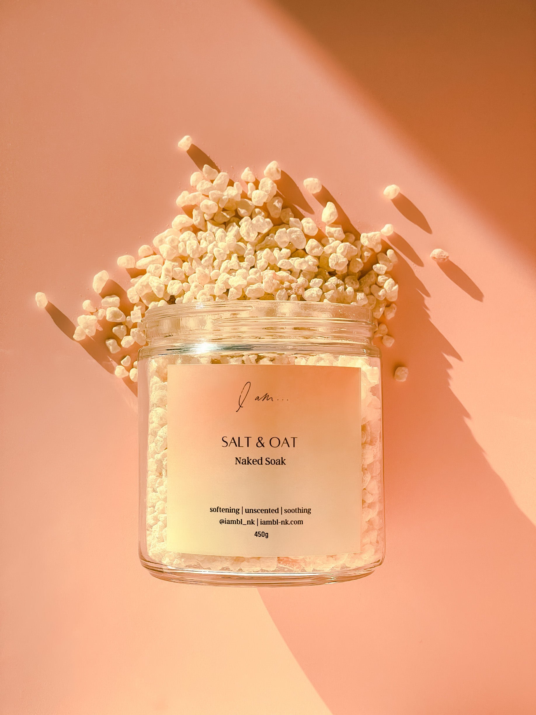 Me-Time Rose de mai soak, photo shows a jar flat lay with soak salts and colloidal oats pouring out of the jar